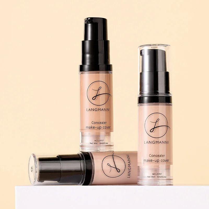 Three Langmanni concealer make-up cover bottles with black pumps on a beige background.