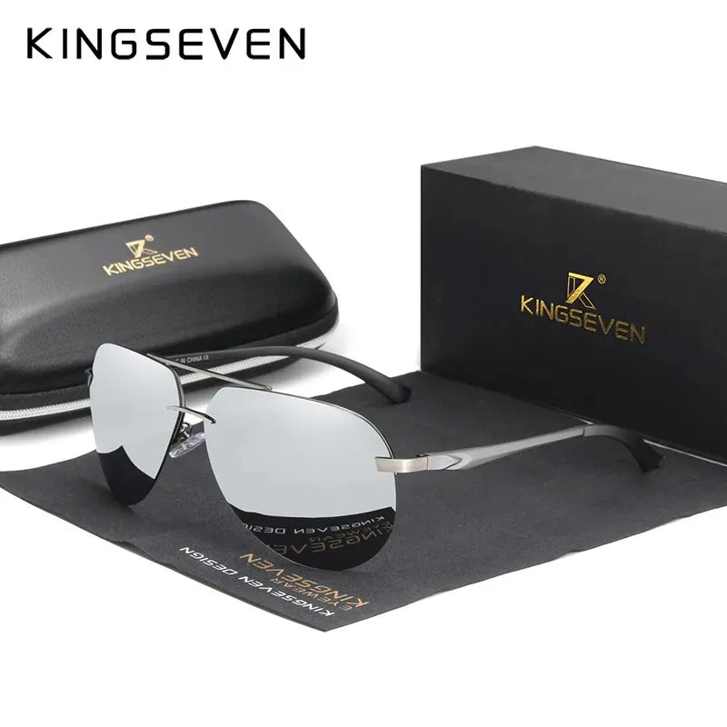 Silver rimless sunglasses with mirrored lenses on display next to black case and box.