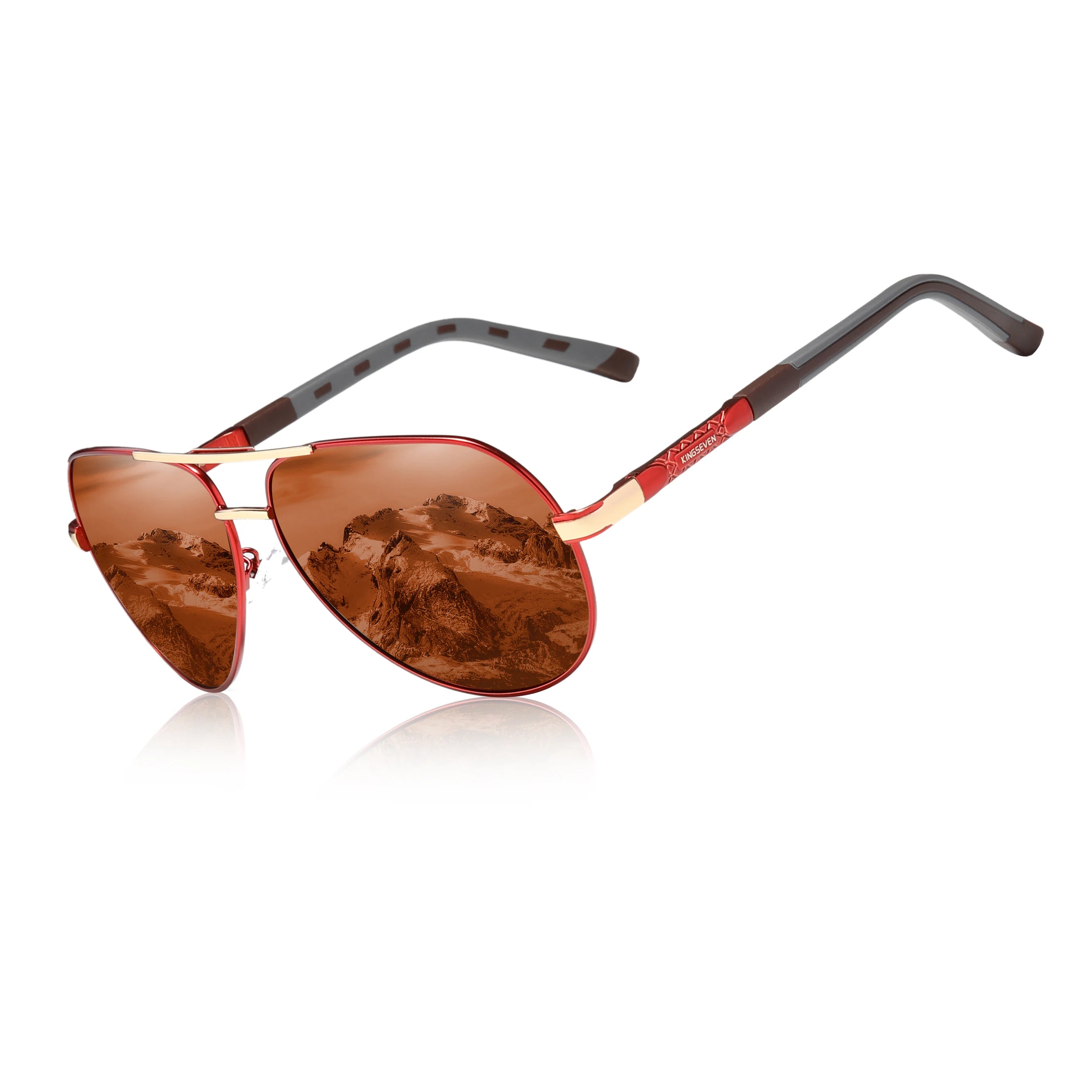 Red aviator sunglasses with brown tinted lenses reflecting mountain scenery