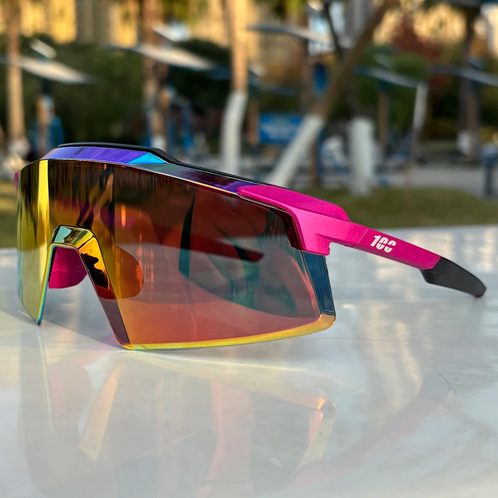 Sports sunglasses with colorful mirrored lens and pink frame on outdoor table