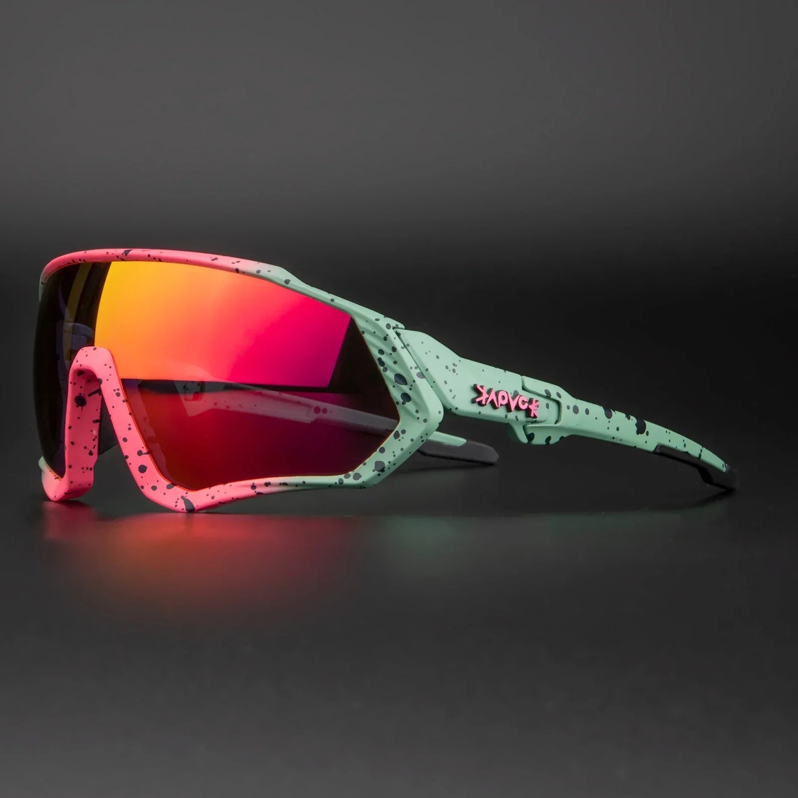 Sport sunglasses with pink and mint splatter frame and mirrored red lens on black background