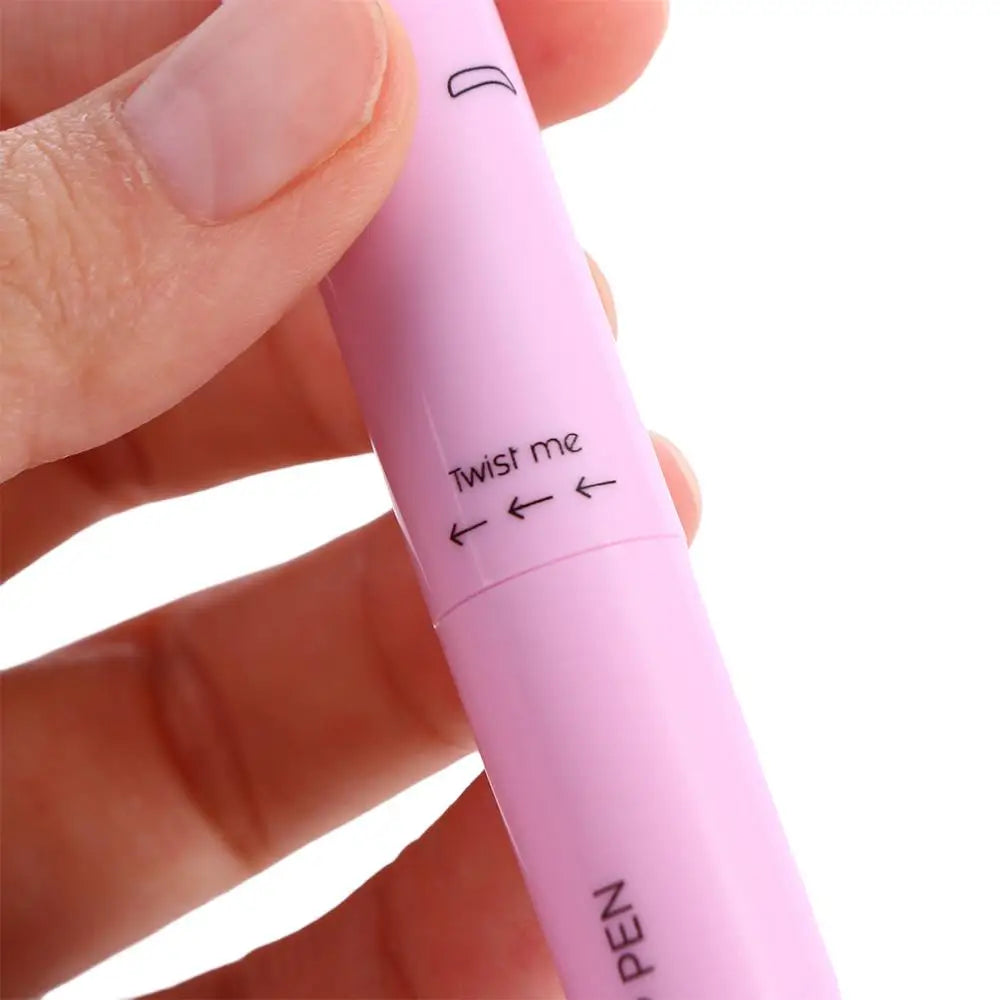 Hand holding a pink twistable pen for makeup or beauty use, close-up view