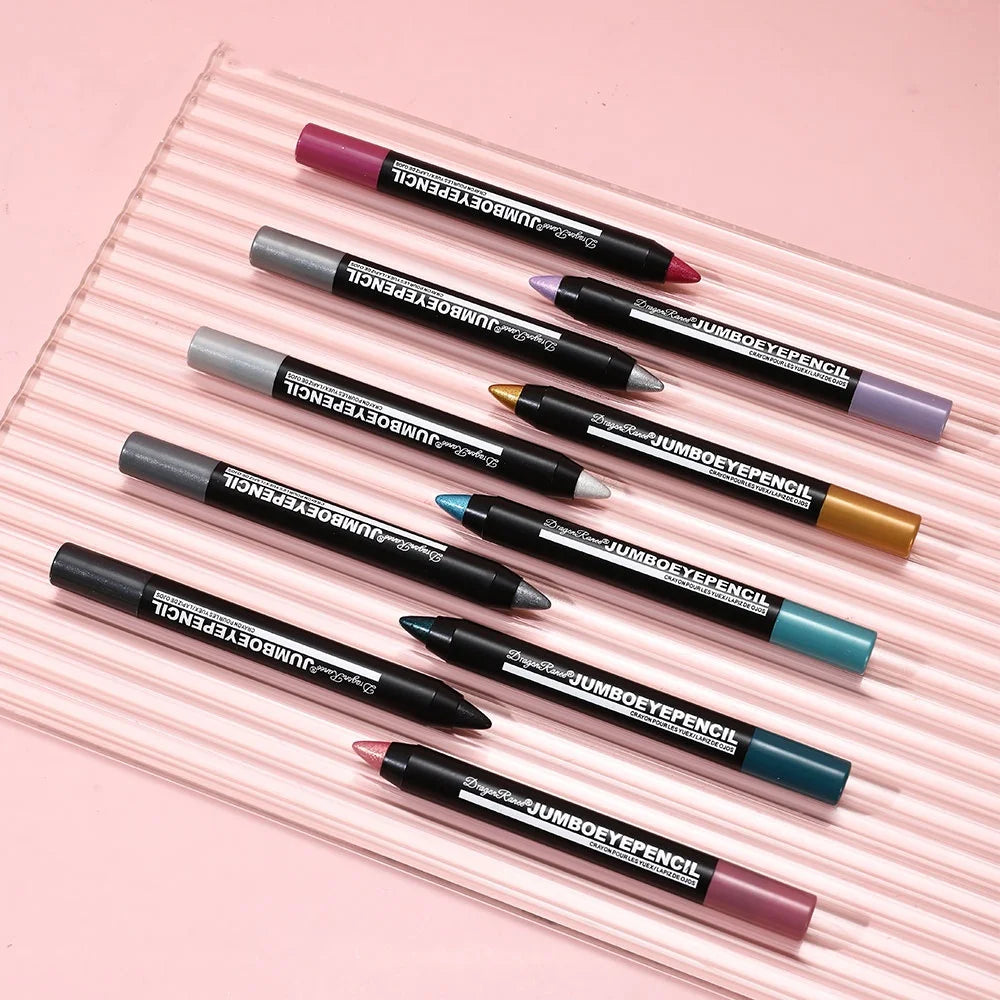 Set of colorful jumbo eye pencils on a pink striped surface, multi-shade makeup crayons