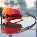 Sport sunglasses with red mirrored lenses reflecting cityscape and trees, gray frame