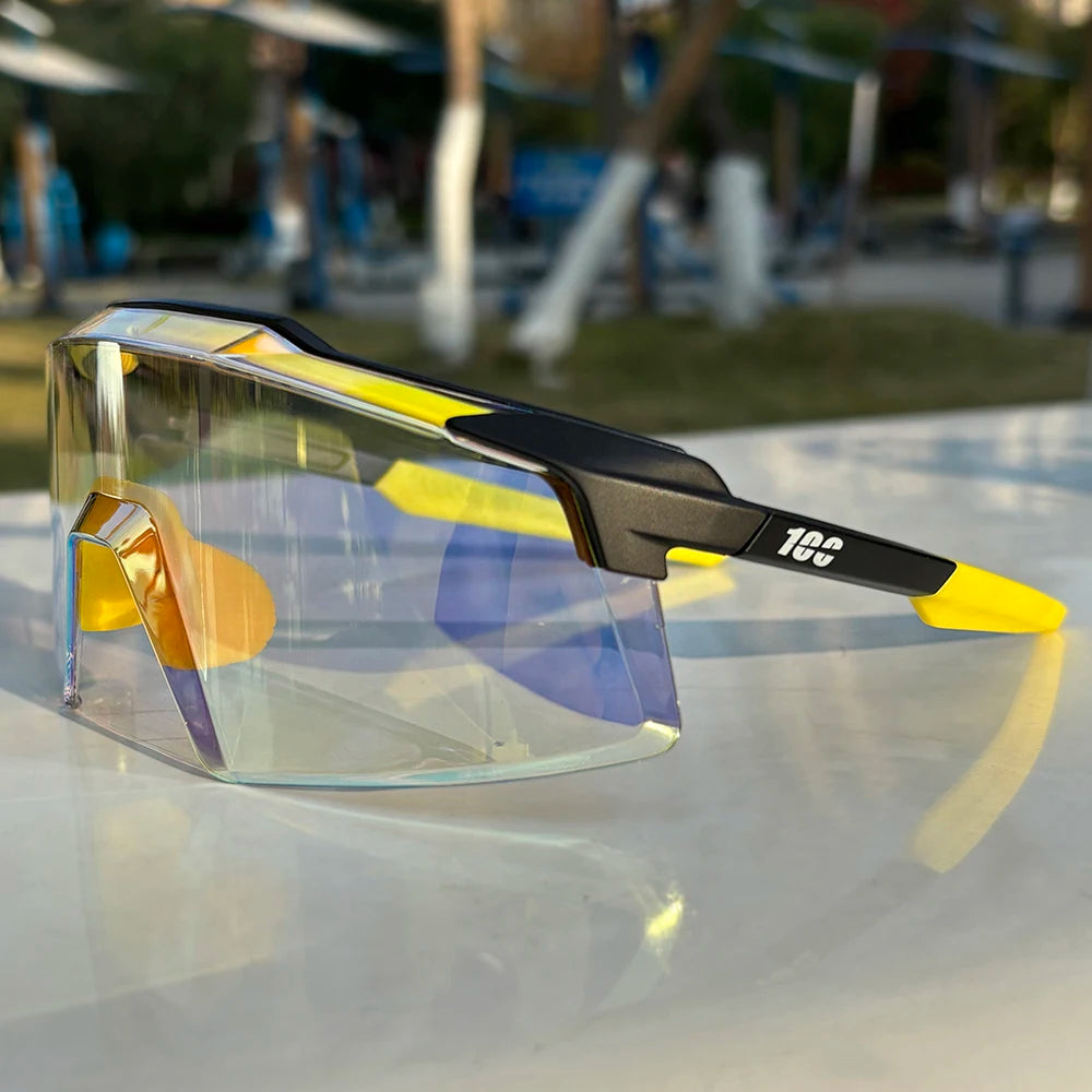 Futuristic yellow and black sports sunglasses with tinted shield lenses on outdoor table