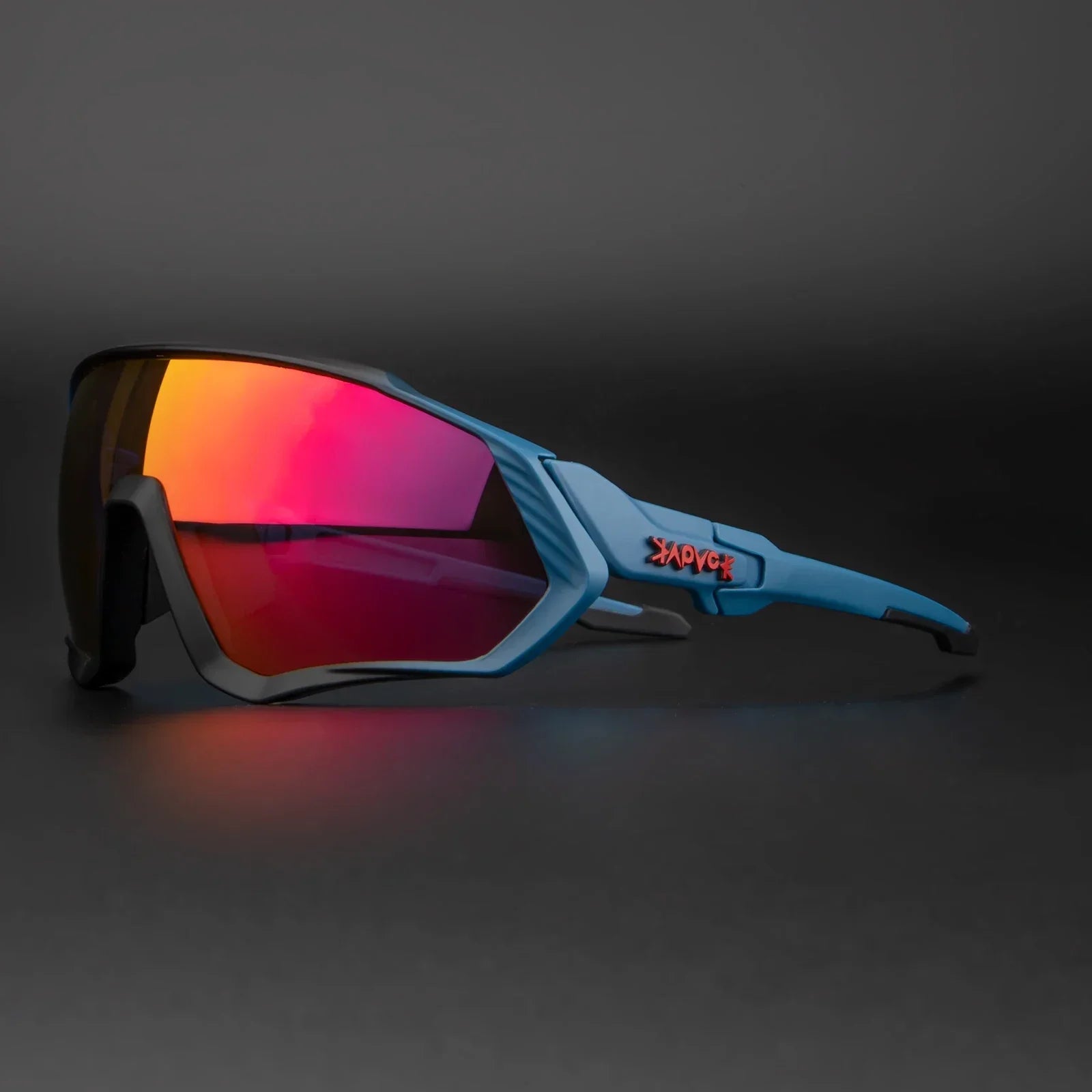 Sporty blue sunglasses with red mirrored lenses on dark background