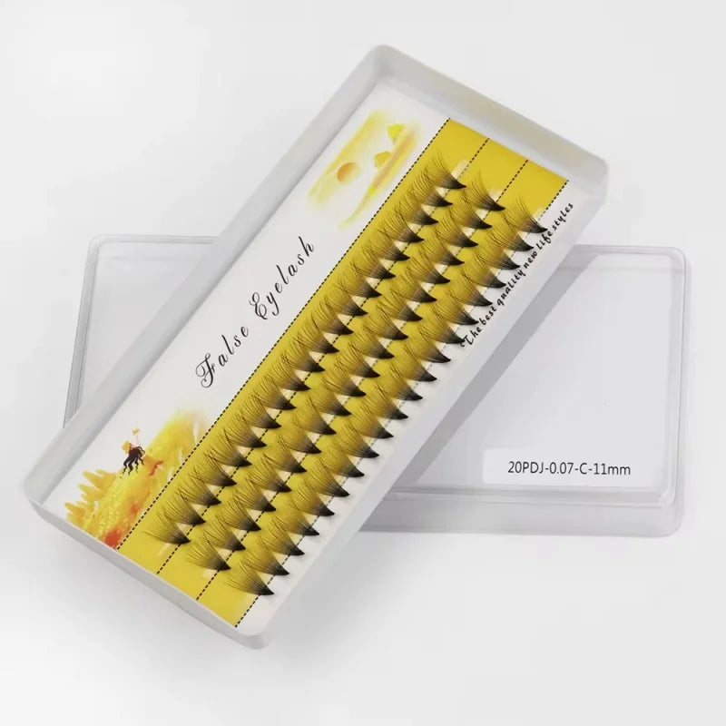Tray of yellow cluster false eyelashes, labeled 20PDJ-0.07-C-11mm, on white background.