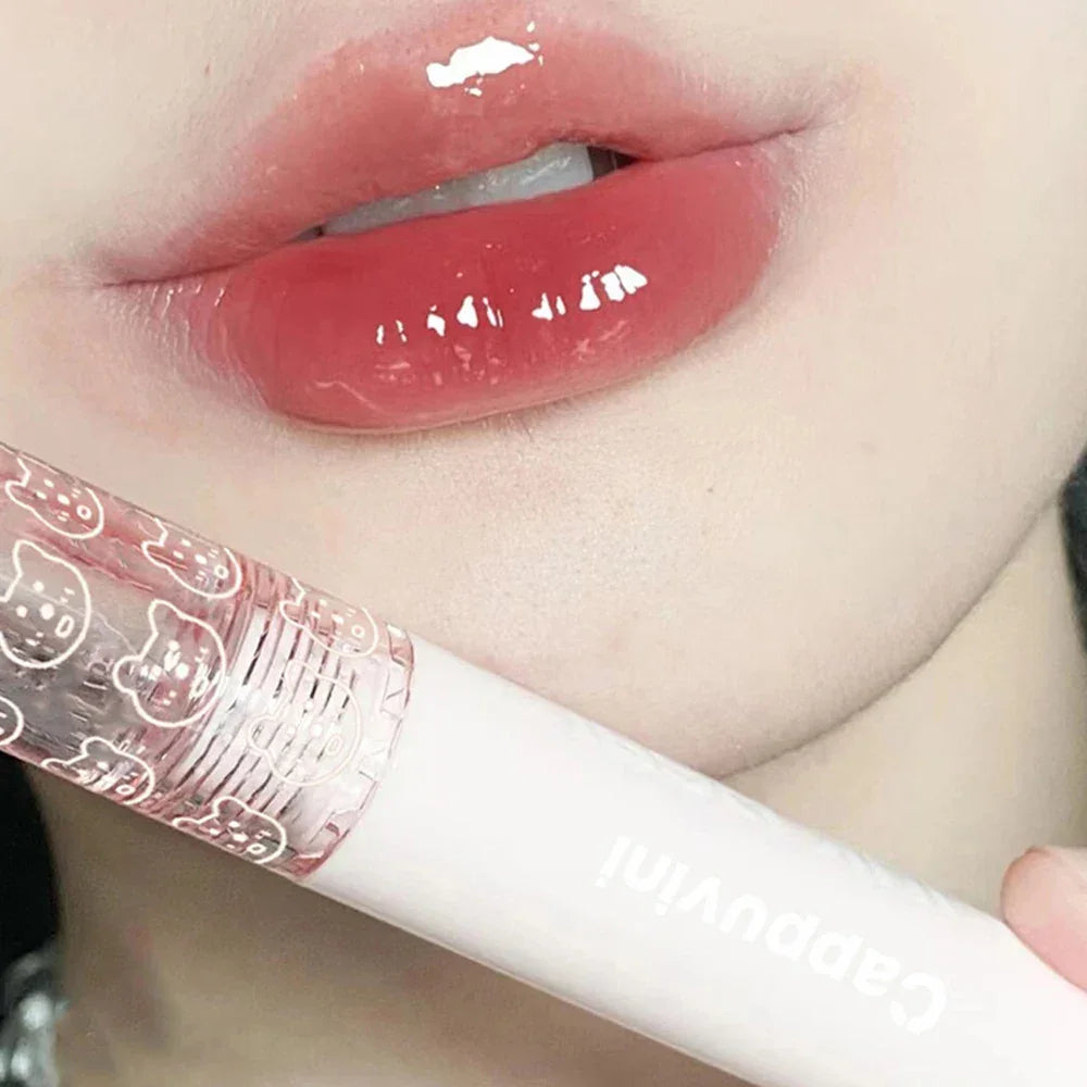 Glossy pink lips with clear lip gloss tube featuring cute bear designs