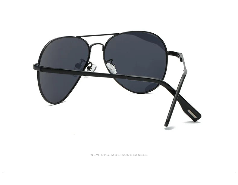 Black aviator sunglasses with dark lenses and sleek metal frame on white background