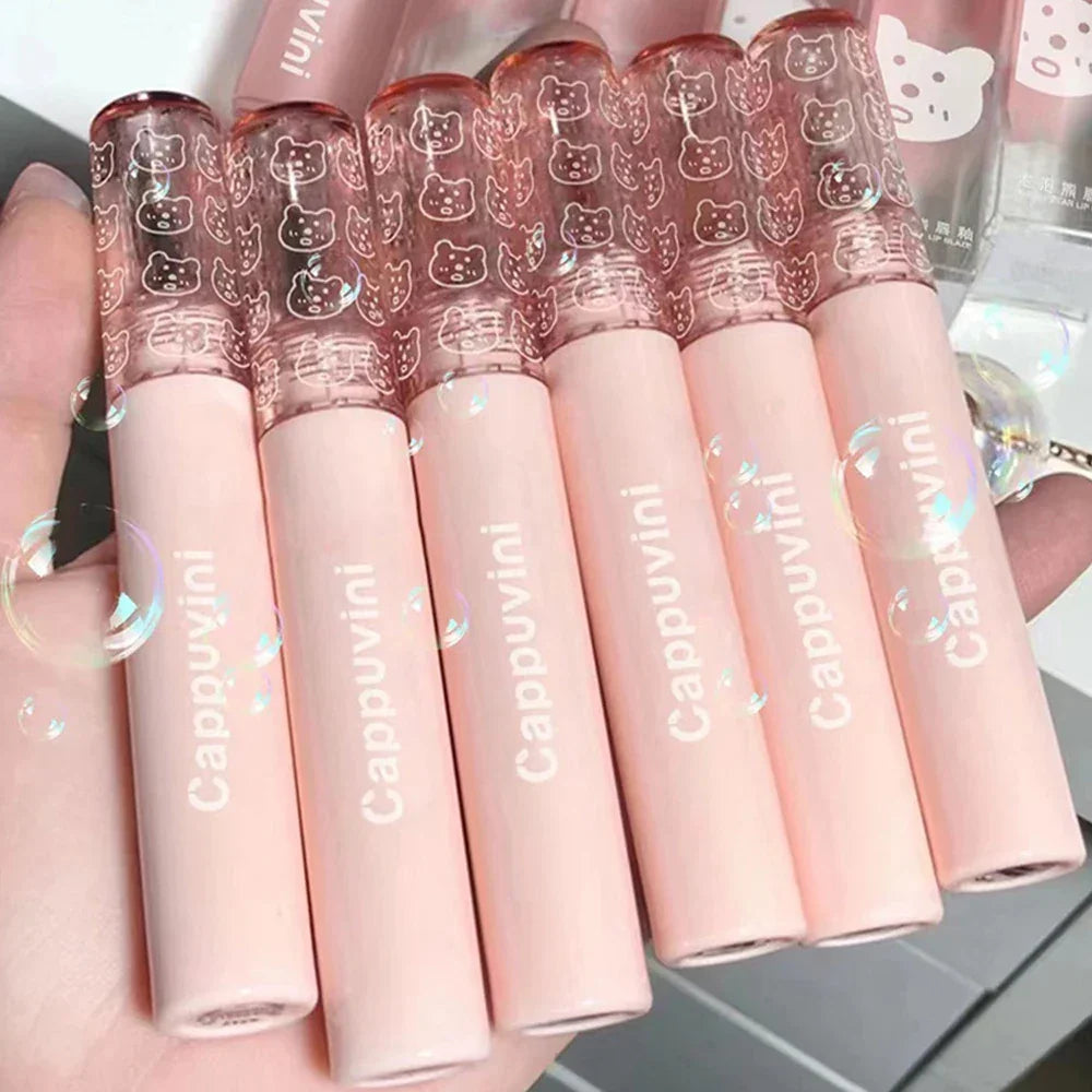 Set of six pink Cappuvini lip gloss tubes with cute animal print lids, handheld display