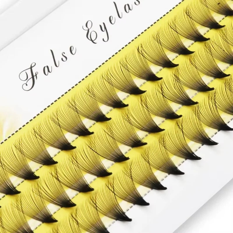 Tray of yellow and black cluster false eyelashes for eye makeup