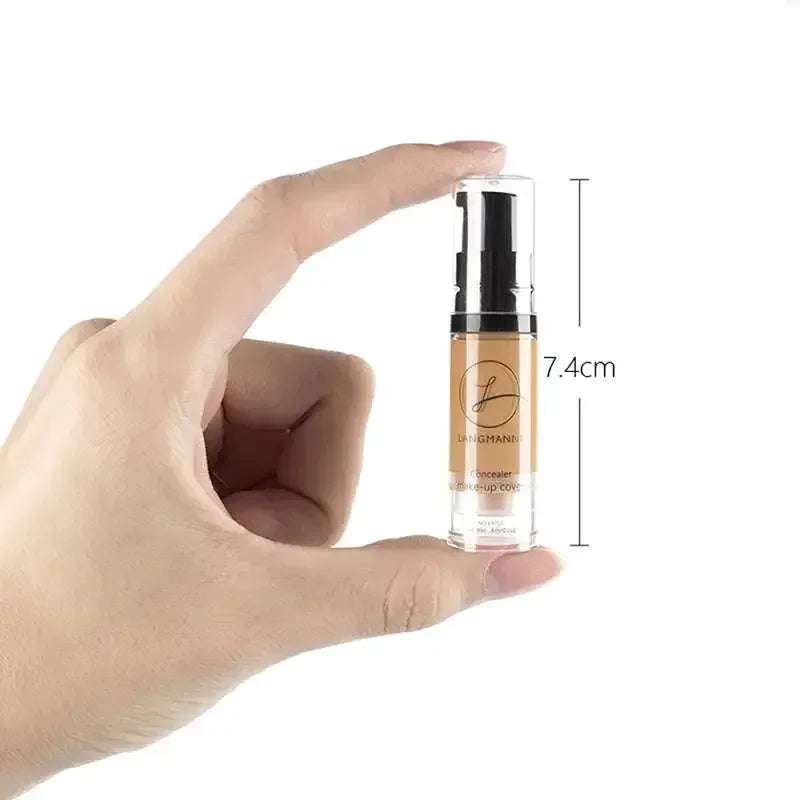 Hand holding a 7.4cm liquid concealer makeup bottle with pump dispenser