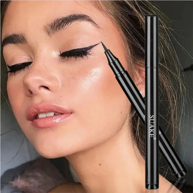 Woman with bold black winged eyeliner and black liquid eyeliner pen, close-up makeup look