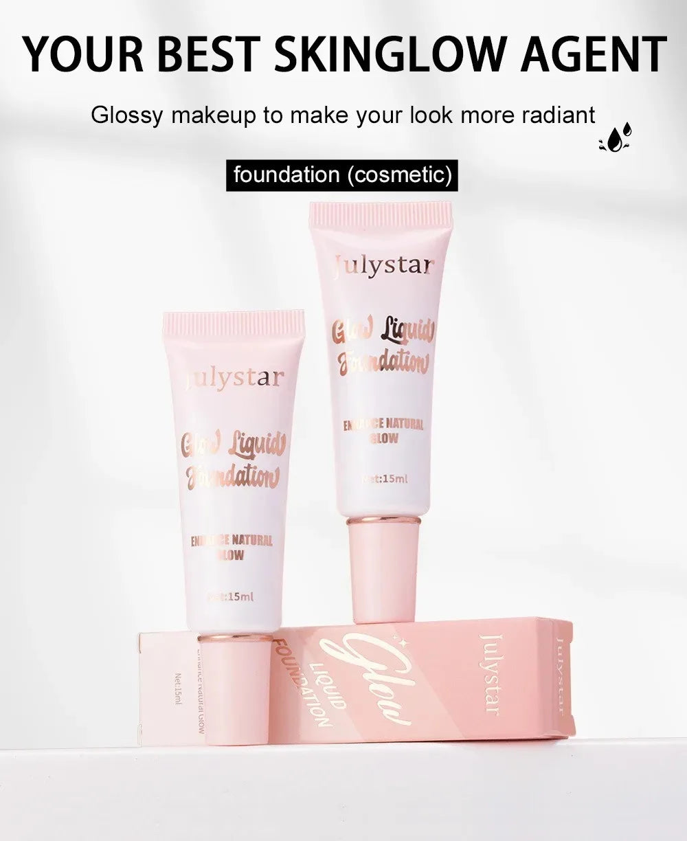 Two Julystar Glow Liquid Foundation tubes and a pink box on a white background, glossy makeup.