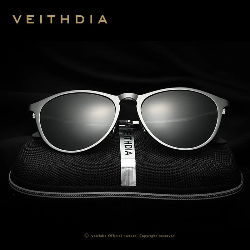 Sleek silver-rimmed sunglasses with dark lenses on a black zippered case, stylish accessory