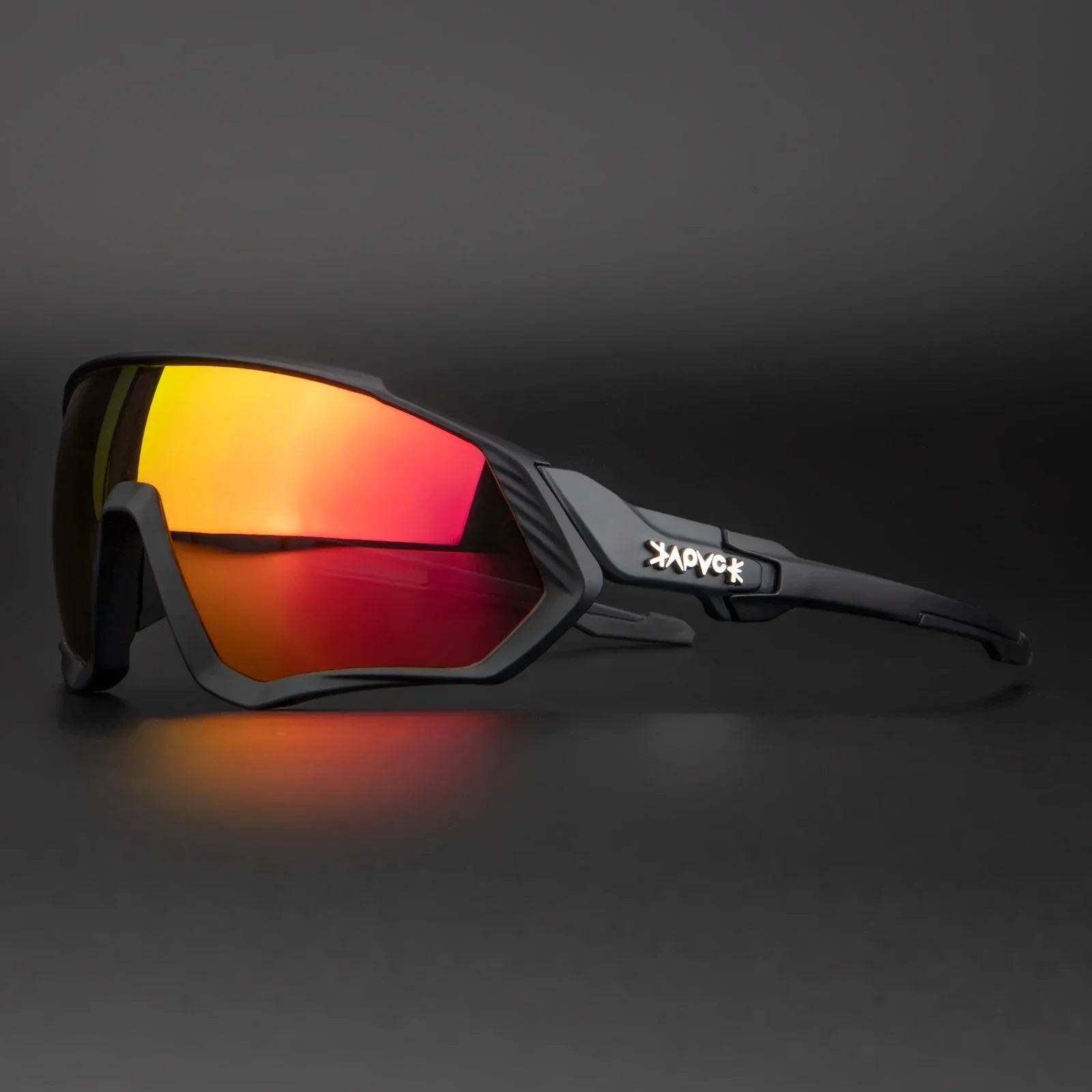 Black sports sunglasses with red mirrored lenses and angular frame on dark background