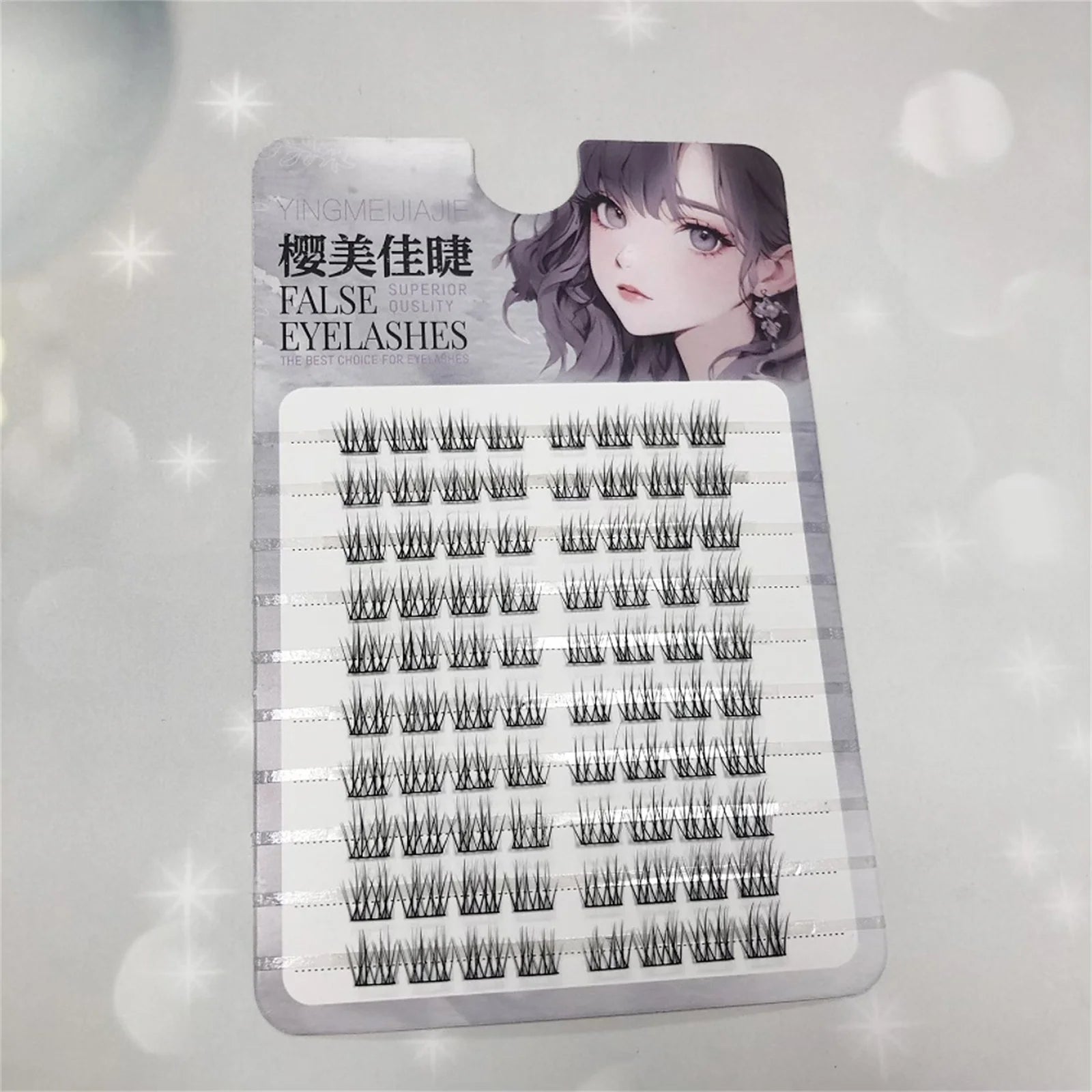 Tray of clustered false eyelashes with illustrated woman on the packaging, beauty accessory