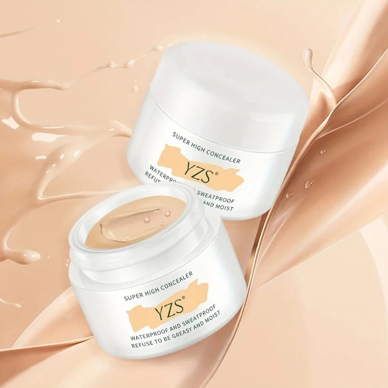 Two jars of YZS high coverage waterproof concealer cream on a beige liquid background