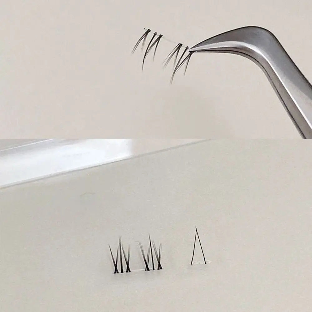 Eyelash extension clusters held by tweezer, with individual lash fans displayed on table.