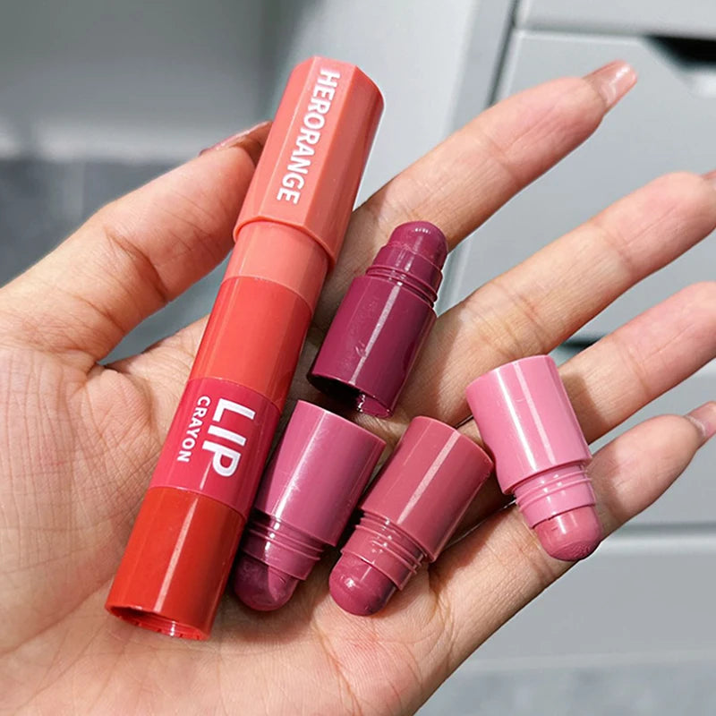 Hand holding multi-color lip crayon set with pink, mauve, and red lipstick shades
