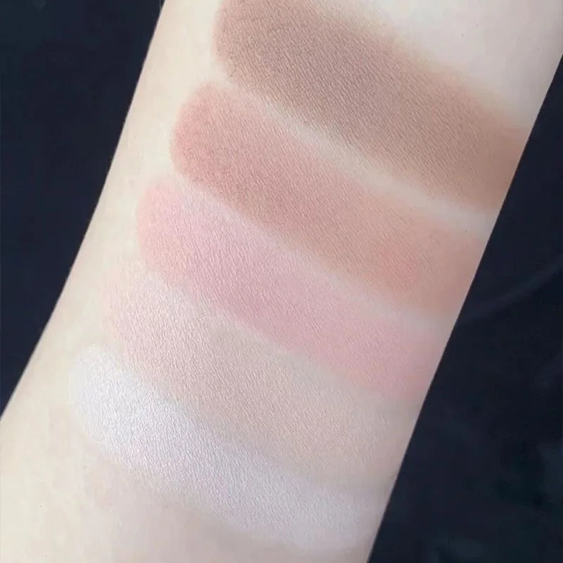 Arm showing swatches of neutral and pink eyeshadow shades on skin