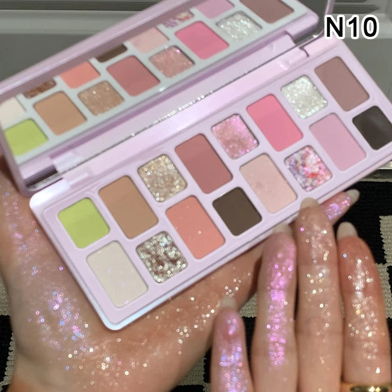 Person holding pastel glitter eyeshadow palette with pink, brown, and green shades, labeled N10
