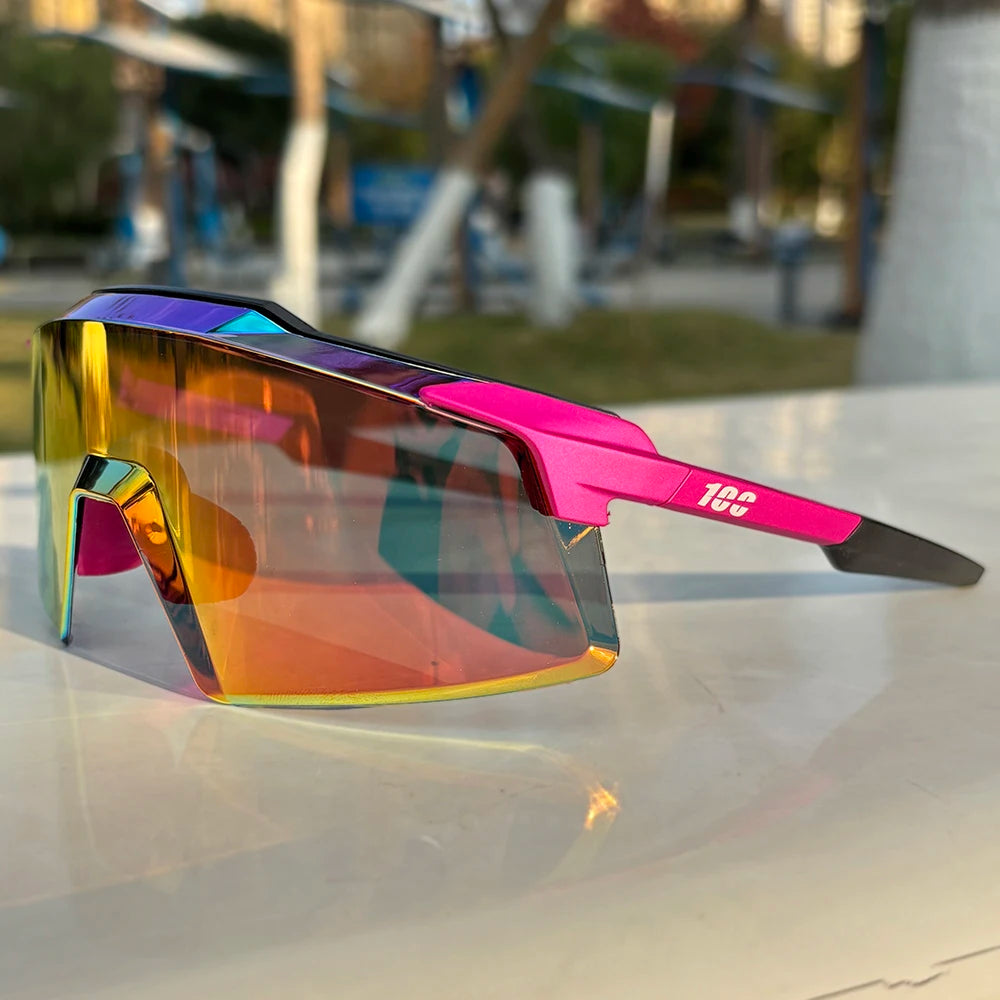 Sporty oversized sunglasses with mirrored rainbow lenses and pink frame on outdoor table