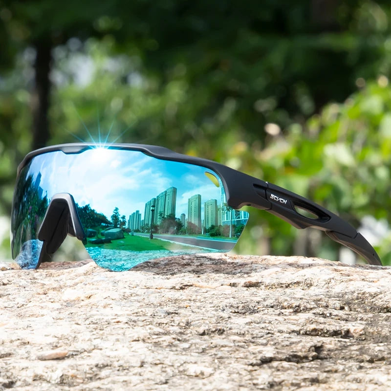 Sport sunglasses with blue reflective lenses and black frame on a rock outdoors