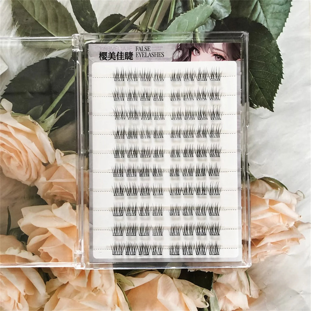 Tray of individual cluster false eyelashes on floral background