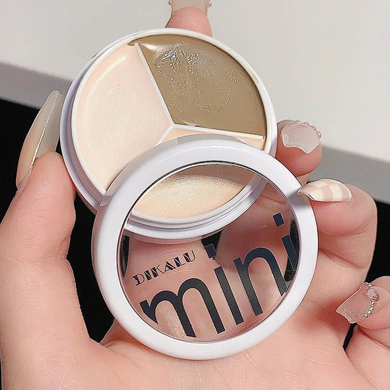 Hand holding a DIKALU mini concealer palette with three shades for makeup and contouring