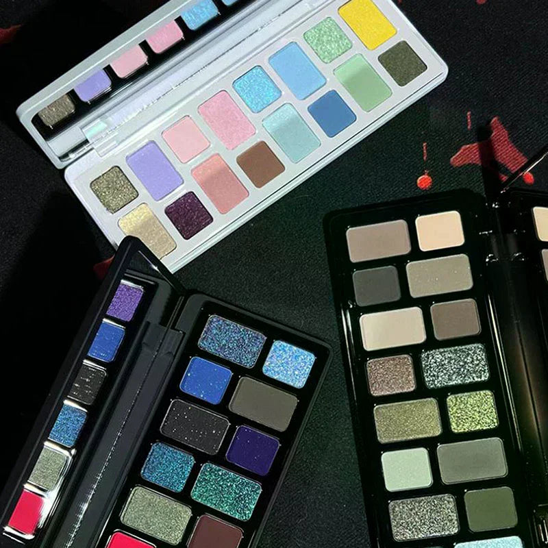 Assorted makeup eyeshadow palettes with matte and shimmer colors on a dark surface